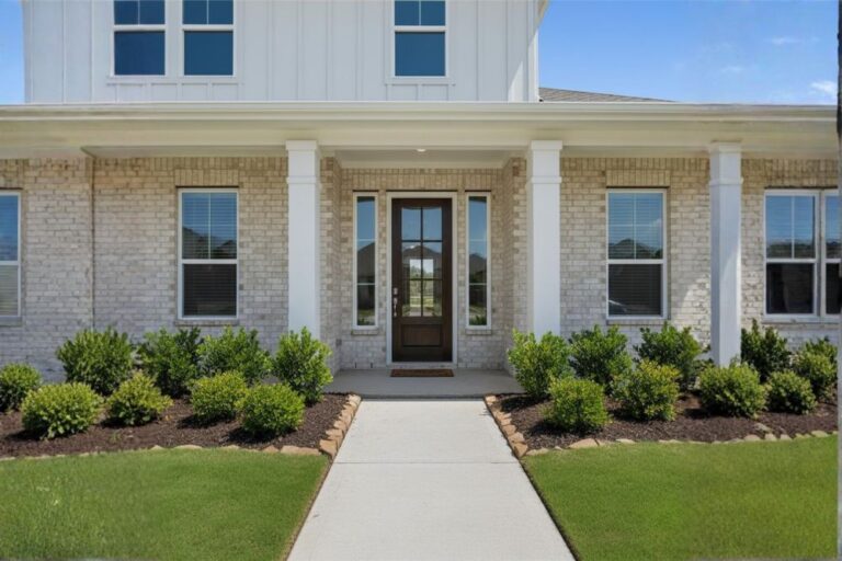 Front entryway of a Cane Island home in Katy, Texas with aligned door and landscaping.