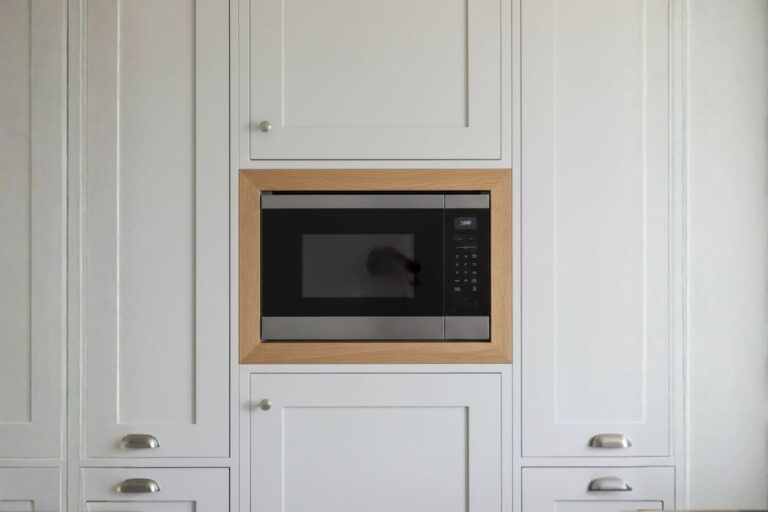 Built-in microwave professionally installed inside kitchen cabinetry in a Katy, Texas home.