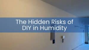 A long, finished white wall in a garage showing the results of a large-scale drywall repair.